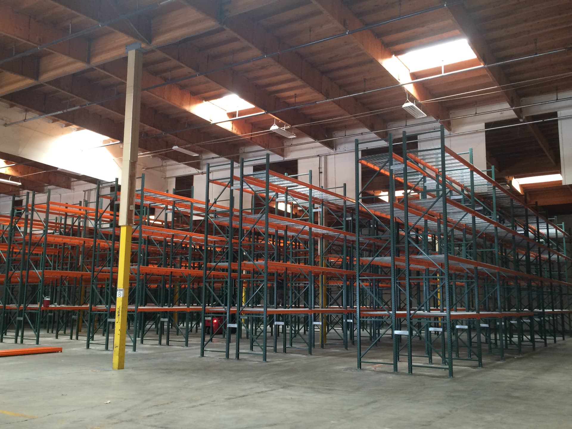 Warehouse racking system installed beneath skylights and ready for inventory