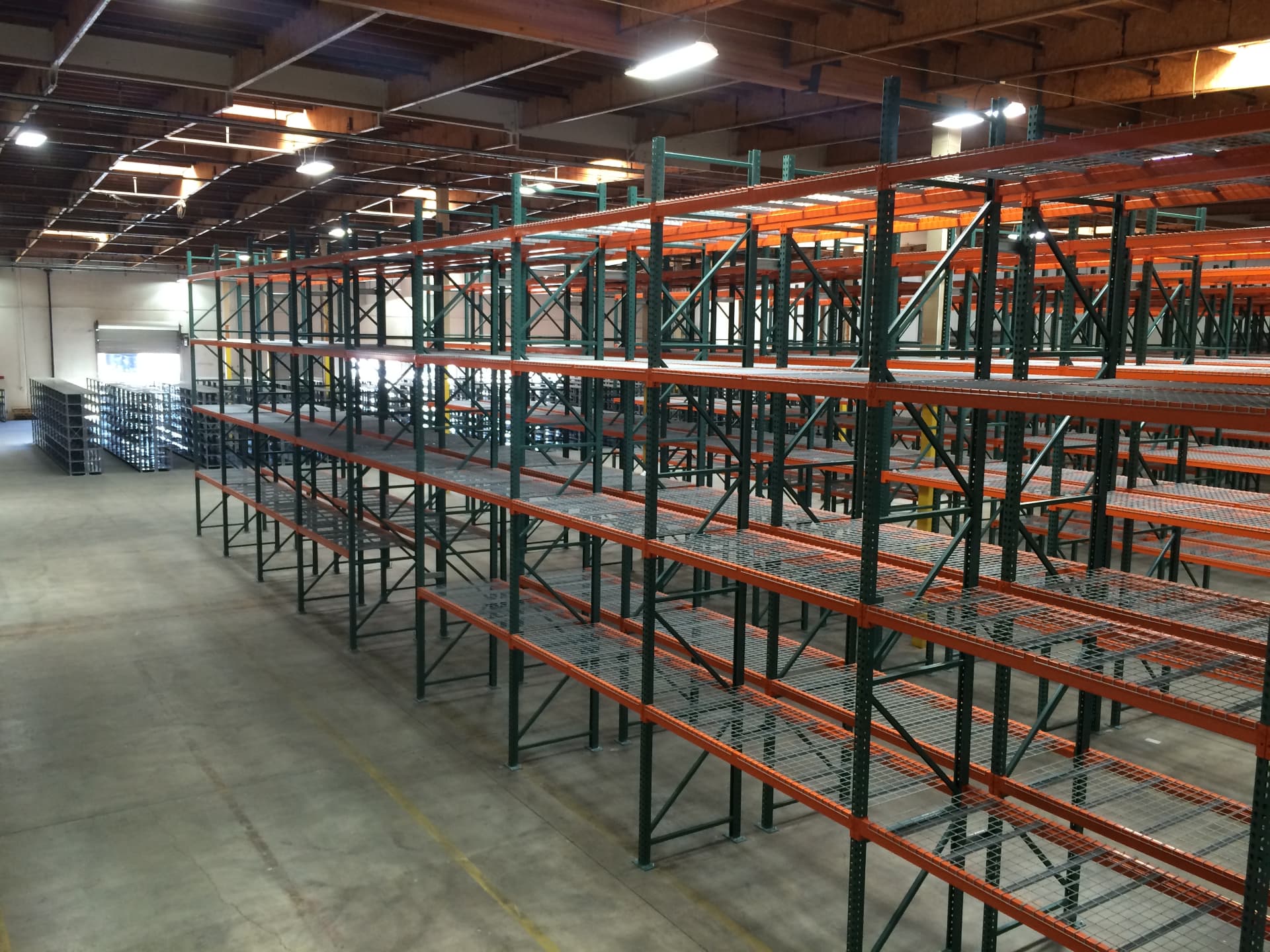 Aisles of pallet racking with wire decking inside a large distribution center